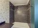 Elegant bathroom showcasing a tiled shower with mosaic accents and custom bird-themed wallpaper at 1717 Ramblewood Way, Snellville, GA 30078