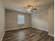 Bedroom featuring hardwood floors, a ceiling fan and a large window at 1717 Ramblewood Way, Snellville, GA 30078