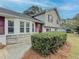 Charming home exterior with brick details, complemented by a well-maintained lawn and beautiful landscaping at 1717 Ramblewood Way, Snellville, GA 30078