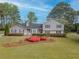 Charming home featuring beautiful landscaping and a well-manicured lawn in a serene, tree-lined neighborhood at 1717 Ramblewood Way, Snellville, GA 30078