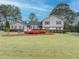 Charming home featuring beautiful landscaping and a well-manicured lawn in a serene, tree-lined neighborhood at 1717 Ramblewood Way, Snellville, GA 30078