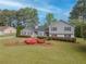 Charming home featuring beautiful landscaping and a well-manicured lawn in a serene, tree-lined neighborhood at 1717 Ramblewood Way, Snellville, GA 30078