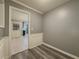 Hallway featuring modern flooring and neutral colored walls with wainscoting, leading to the kitchen at 1717 Ramblewood Way, Snellville, GA 30078