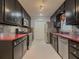 Galley kitchen featuring stainless steel appliances, a gas range, and bold red countertops at 1717 Ramblewood Way, Snellville, GA 30078