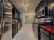 Modern kitchen featuring stainless steel appliances, sleek black cabinets, and stylish countertops for a chef's delight at 1717 Ramblewood Way, Snellville, GA 30078