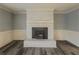 Bright living room showcasing a cozy fireplace, modern flooring and neutral walls providing a warm ambiance at 1717 Ramblewood Way, Snellville, GA 30078