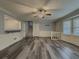 Bright living room featuring updated flooring, a ceiling fan, and natural light from large windows providing a cozy ambiance at 1717 Ramblewood Way, Snellville, GA 30078
