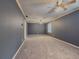Spacious living room featuring neutral carpet, two ceiling fans and a large window at 1717 Ramblewood Way, Snellville, GA 30078