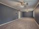 Large living room featuring plush carpeting and large windows for ample natural light at 1717 Ramblewood Way, Snellville, GA 30078