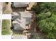 Aerial view of a single Gathering home featuring a deck, driveway, and manicured landscaping at 4421 Wooded Oaks Nw, Kennesaw, GA 30152