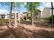 Expansive backyard view showcasing mature trees, mulch cover, and neighboring homes, offering a sense of community at 4421 Wooded Oaks Nw, Kennesaw, GA 30152