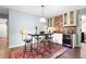 Wet bar featuring wood floors, seating for four, granite countertop and stainless-steel wine cooler at 4421 Wooded Oaks Nw, Kennesaw, GA 30152