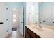 Bright bathroom featuring a white sink, dark wood cabinets, and ceramic tile flooring at 4421 Wooded Oaks Nw, Kennesaw, GA 30152