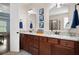 Well-lit bathroom with dual sink vanity, granite countertops, and framed mirrors at 4421 Wooded Oaks Nw, Kennesaw, GA 30152
