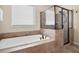 Beautiful white tub and tile shower surround, offering a luxurious spa experience at 4421 Wooded Oaks Nw, Kennesaw, GA 30152