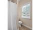 Bathroom with toilet and shower with curtain and a view of the neighborhood at 4421 Wooded Oaks Nw, Kennesaw, GA 30152
