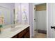 Bathroom features a vanity with dark cabinets, a mirror and access to a shower with curtain at 4421 Wooded Oaks Nw, Kennesaw, GA 30152