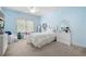 Cozy bedroom with a light-blue color scheme, plush carpet, and lots of natural light from the window at 4421 Wooded Oaks Nw, Kennesaw, GA 30152
