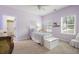 Cozy bedroom with two windows, light purple walls, and carpet at 4421 Wooded Oaks Nw, Kennesaw, GA 30152