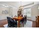 Bright dining area featuring hardwood floors, a wooden table with blue chairs, and elegant trim at 4421 Wooded Oaks Nw, Kennesaw, GA 30152