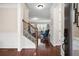 Warm and inviting foyer with hardwood floors, staircase with wood and iron railings, and neutral wall colors at 4421 Wooded Oaks Nw, Kennesaw, GA 30152