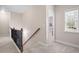 Upstairs hallway features carpeted floors, wood railing, and natural light at 4421 Wooded Oaks Nw, Kennesaw, GA 30152