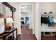 Inviting hallway with hardwood floors, built-in storage, and a view into the living room with fireplace at 4421 Wooded Oaks Nw, Kennesaw, GA 30152