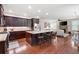 Open-concept kitchen with island seating, a gas range, and seamless flow into the living area at 4421 Wooded Oaks Nw, Kennesaw, GA 30152