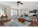 Inviting living room with hardwood floors, area rug, and a view into the modern kitchen at 4421 Wooded Oaks Nw, Kennesaw, GA 30152