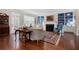 Cozy living room featuring hardwood floors, fireplace, and custom shelving for decor and storage at 4421 Wooded Oaks Nw, Kennesaw, GA 30152