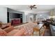 Comfortable living room featuring hardwood floors, plush seating, a ceiling fan, and large windows for natural light at 4421 Wooded Oaks Nw, Kennesaw, GA 30152