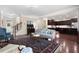 Open-concept living space with hardwood floors leading to the kitchen and ample natural light at 4421 Wooded Oaks Nw, Kennesaw, GA 30152