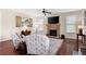 Inviting living room with a stone fireplace and plentiful natural light streaming through large windows at 4421 Wooded Oaks Nw, Kennesaw, GA 30152