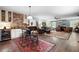 Open-concept living room with bar featuring dark hardwood floors, comfortable seating, and a brick accent wall at 4421 Wooded Oaks Nw, Kennesaw, GA 30152