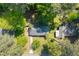 An aerial view showcases this charming home with a driveway, surrounded by lush, mature trees and greenery at 573 Lyle Se Dr, Marietta, GA 30067