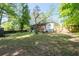 Spacious backyard featuring mature trees, providing shade and privacy for outdoor enjoyment at 573 Lyle Se Dr, Marietta, GA 30067
