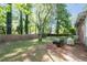 Spacious backyard with a privacy fence, mature trees, a fire pit, and plenty of room for outdoor activities at 573 Lyle Se Dr, Marietta, GA 30067