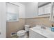 Well-lit bathroom with tile flooring, a toilet, and a sink with a vanity and chrome fixtures at 573 Lyle Se Dr, Marietta, GA 30067