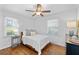 Comfortable bedroom with hardwood floors, large windows, ceiling fan, and a neutral color scheme at 573 Lyle Se Dr, Marietta, GA 30067