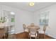Bright breakfast nook features hardwood floors, a round table with seating for four, and a view to the backyard at 573 Lyle Se Dr, Marietta, GA 30067