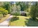 Charming brick home with mature tree in the front yard, showcasing lovely curb appeal at 573 Lyle Se Dr, Marietta, GA 30067