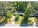 An aerial view of a charming single-story home with a driveway and mature trees at 573 Lyle Se Dr, Marietta, GA 30067