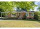 Charming brick ranch home featuring well-maintained landscaping and a convenient covered carport at 573 Lyle Se Dr, Marietta, GA 30067