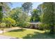 Charming brick home with a well-manicured front lawn and mature trees enhancing curb appeal at 573 Lyle Se Dr, Marietta, GA 30067