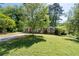 Charming brick home with mature tree in the front yard, showcasing lovely curb appeal at 573 Lyle Se Dr, Marietta, GA 30067