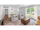 Bright and inviting living room with hardwood floors, large windows, and seamless flow to entryway at 573 Lyle Se Dr, Marietta, GA 30067