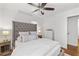Comfortable main bedroom with ceiling fan features a tufted headboard, and hardwood floors with area rug at 573 Lyle Se Dr, Marietta, GA 30067