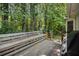 Spacious wooden back deck surrounded by mature trees, offering outdoor living space at 258 Cristy Dr, Dallas, GA 30157