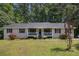 Charming single-story home with a cozy front porch and a well-manicured lawn surrounded by mature trees at 258 Cristy Dr, Dallas, GA 30157