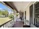 Covered front porch with wood flooring and comfortable seating at 258 Cristy Dr, Dallas, GA 30157
